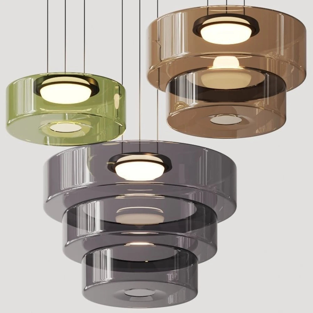 Collection of green, amber, and smoke grey glass pendant lights in various tiers. Ideal for luxury kitchen or dining room lighting.