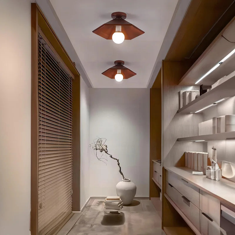 Two walnut wood and brass ceiling lights in a serene hallway with Japanese-inspired decor, enhancing the wabi-sabi aesthetic.