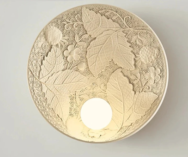 Beige French round wall lamp with embossed leaves and flowers, vintage art deco sconce for hallway or kitchen lighting.