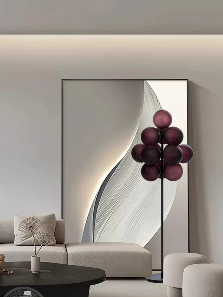 Purple Grape Cluster LED floor lamp placed in a minimal living space, combining sculptural lighting with modern decor.