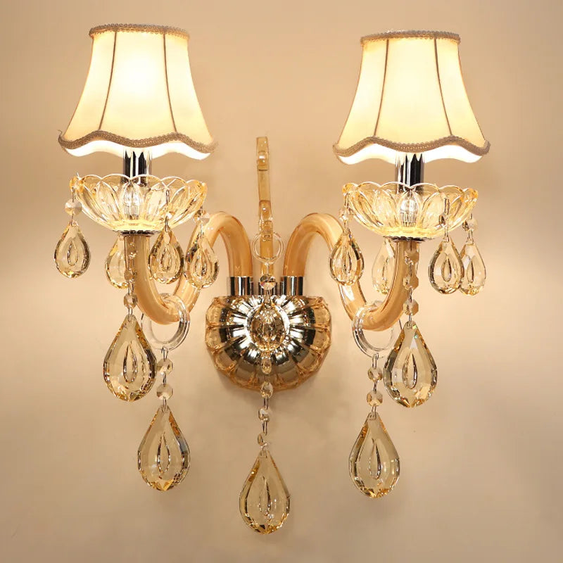 LED Glass Sconce - Modern Crystal Wall Lamp with dual cream fabric shades and teardrop crystals, ideal for luxury living room or bedroom decor.