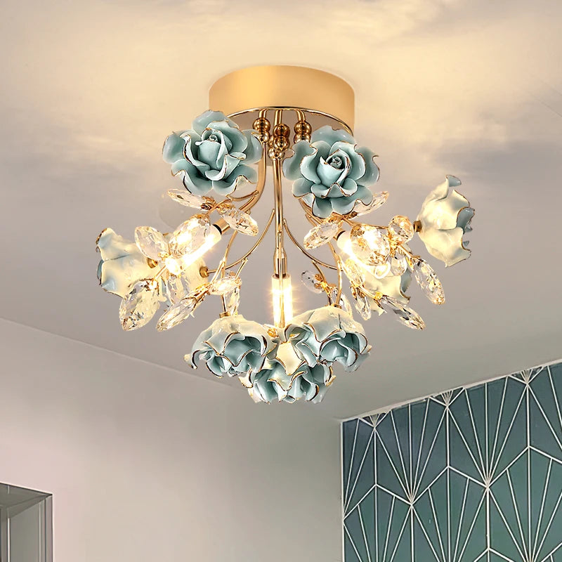Kids rose crystal chandelier in blue with crystal leaves and gold base, ideal for modern children's bedroom or playroom lighting.