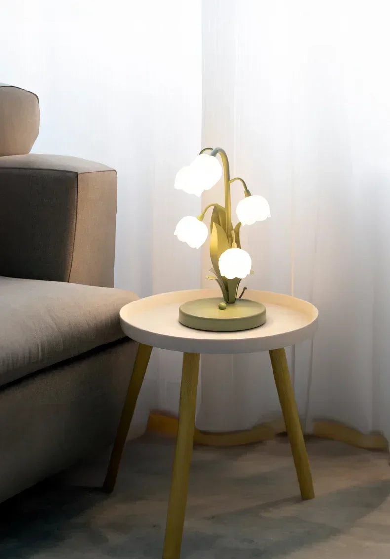 Nordic Atmosphere LED Table Lamp on a round side table, enhancing living room decor with soft tulip-style lighting.
