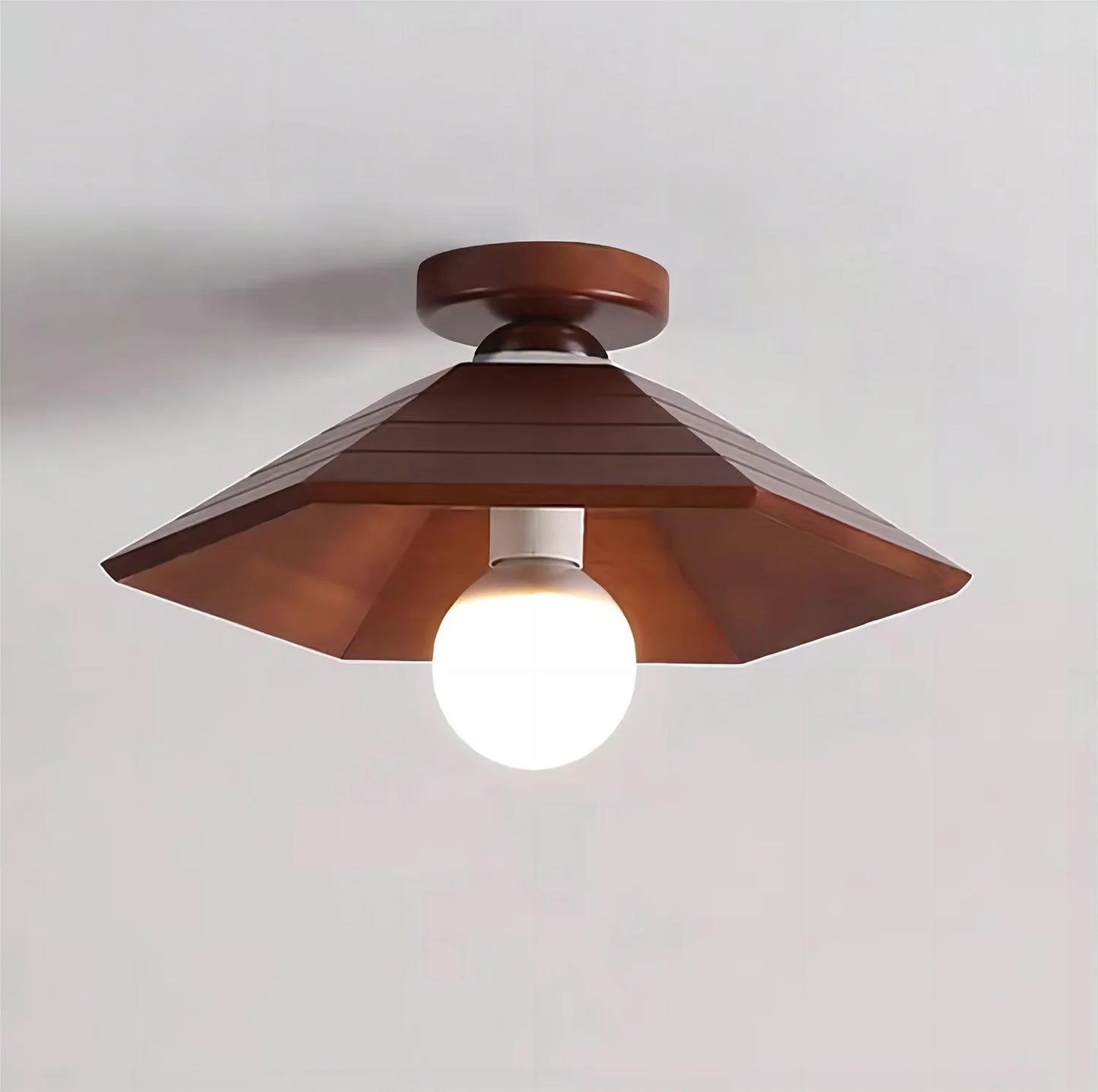 Angular walnut wood ceiling light with central bulb, offering a unique wabi-sabi design for modern and vintage interiors.