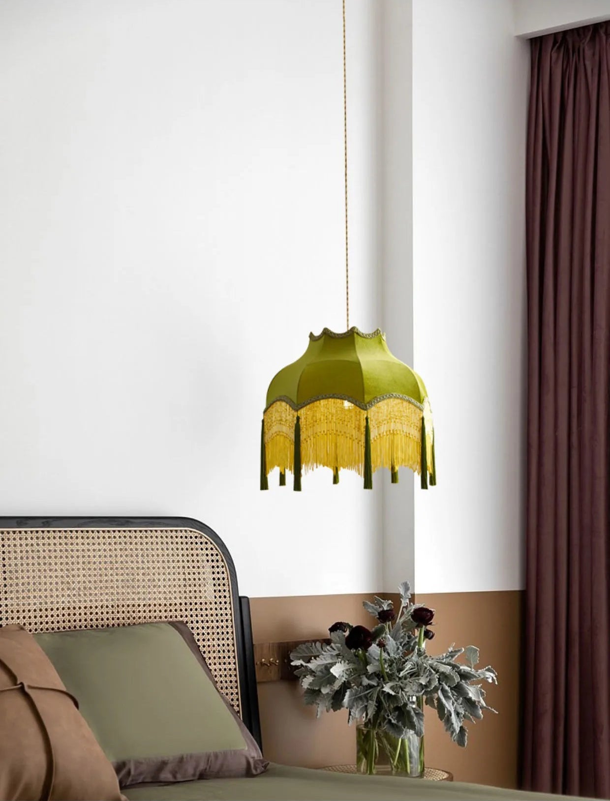 Velvet tassel chandelier - green vintage pendant light beside a bed, creating a cozy and elegant bedroom ambiance.
