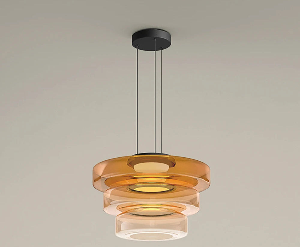 Amber three-tier glass pendant light with LED source. Features 45cm, 35cm, and 25cm diameters for a luxurious layered look.