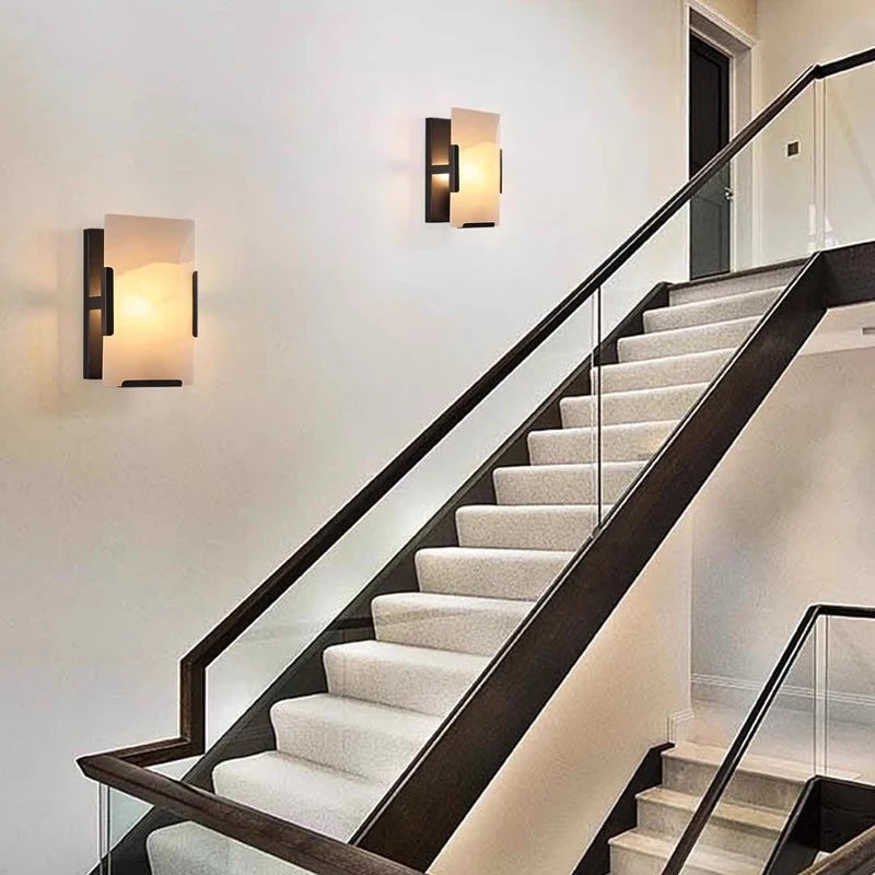 Copper Marble LED Sconce in black finish installed on stairway wall, offering ambient lighting and sleek modern design.