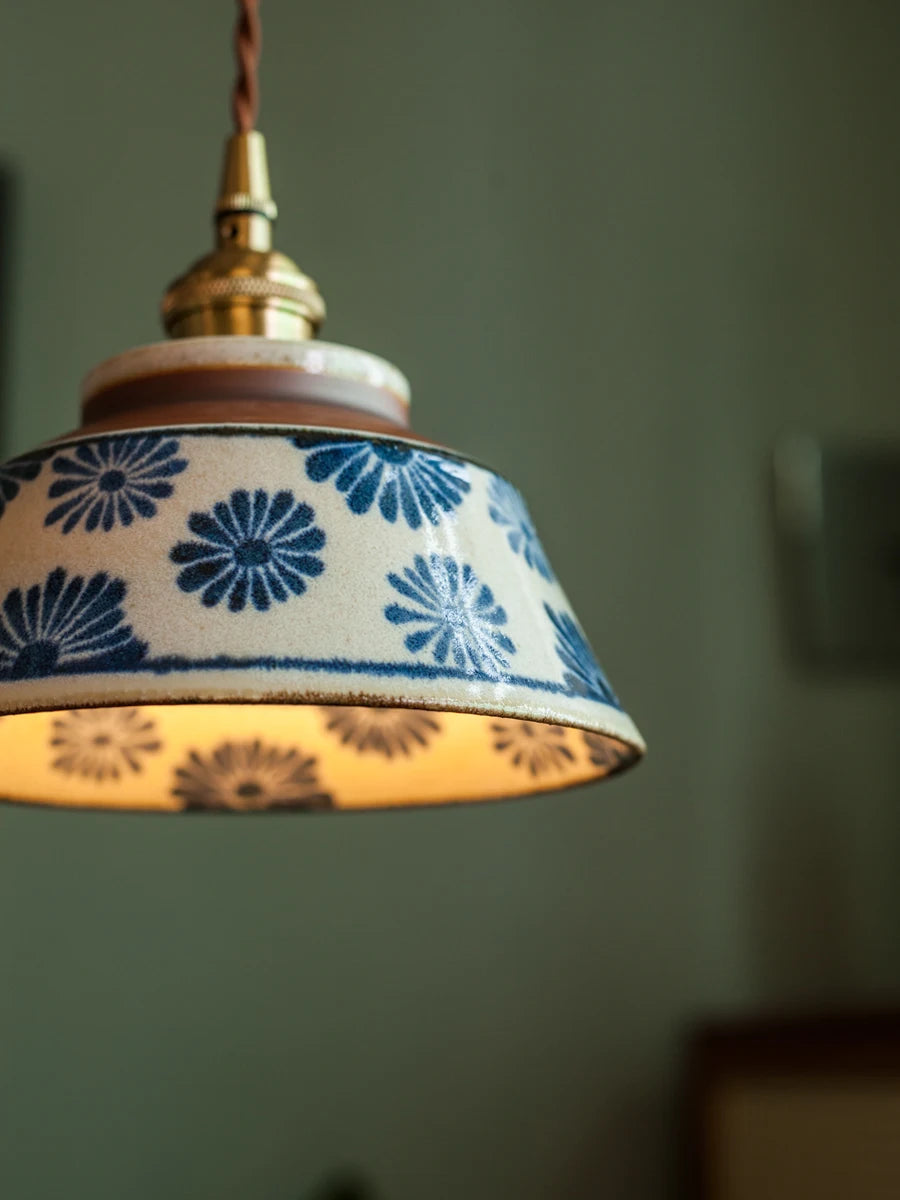 Close-up of Retro Chinese Porcelain Pendant Light with blue floral design. Durable ceramic shade with soft LED illumination.