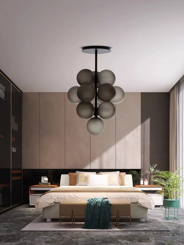 Purple Glass Grape LED Chandelier installed in a contemporary bedroom, offering ambient lighting with a sculptural design.