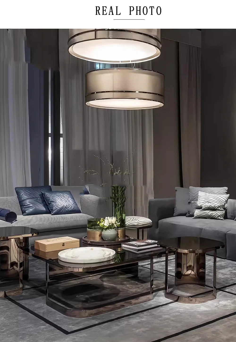 Luxurious Italian designer chandeliers illuminating a modern living room with plush seating and mirrored coffee tables.