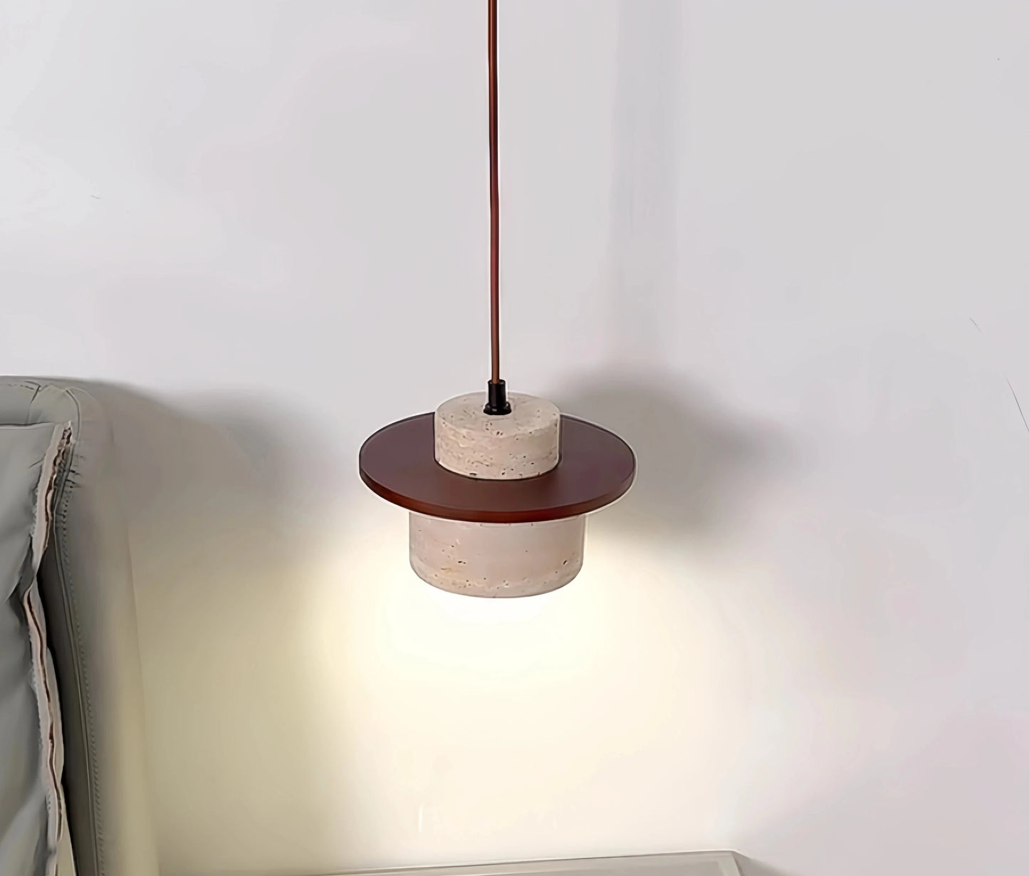 Modern Japanese pendant light with dark wood and travertine finish, ideal for bedside or reading nook lighting in minimalist interiors.