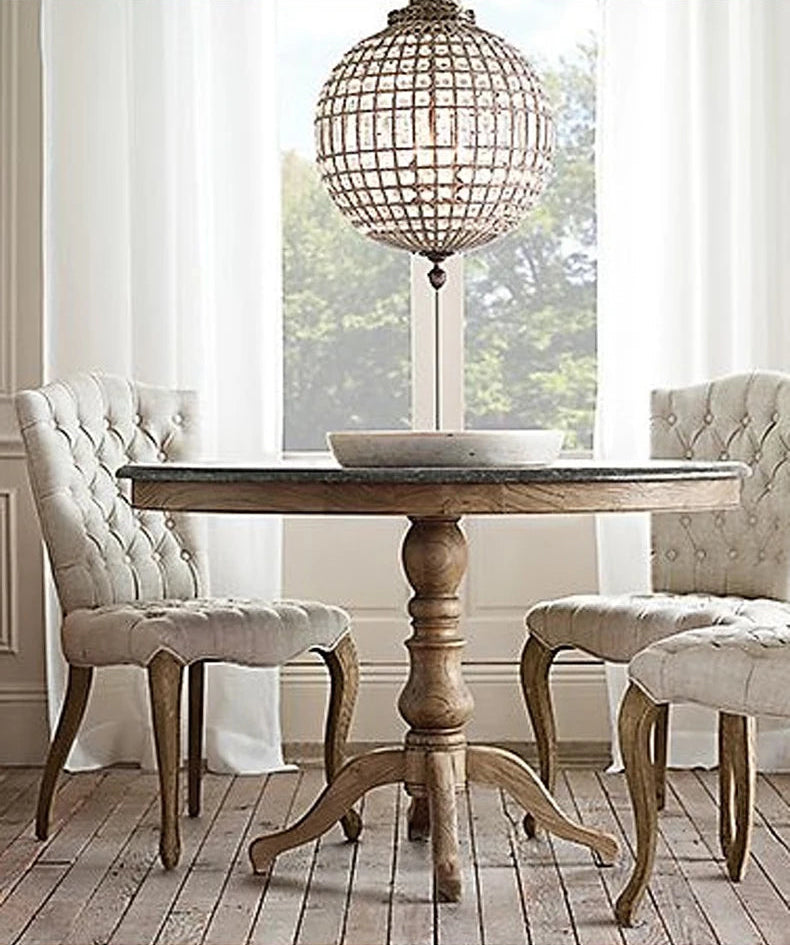 Vintage-style LED Crystal Chandelier suspended above a rustic round table, adding charm to a cozy dining space.
