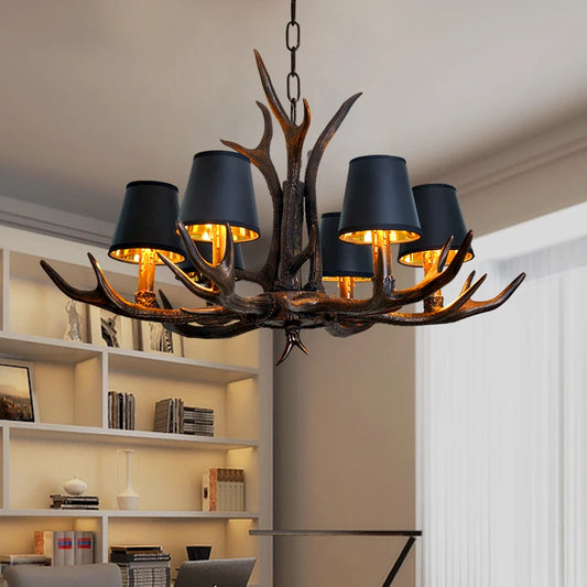 Farmhouse American chandelier with black horn design and six black lampshades, hanging in a modern home office setting.