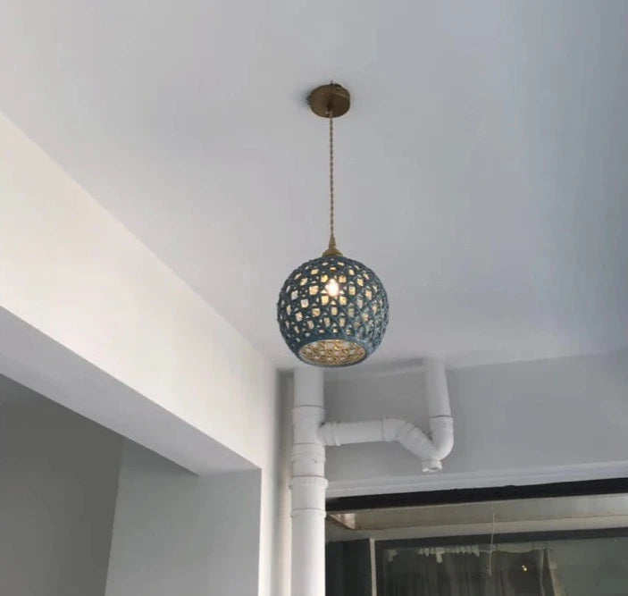 Blue spherical LUXELY ceramic pendant light installed in a modern ceiling, perfect for pendant hotel or kitchen lighting.