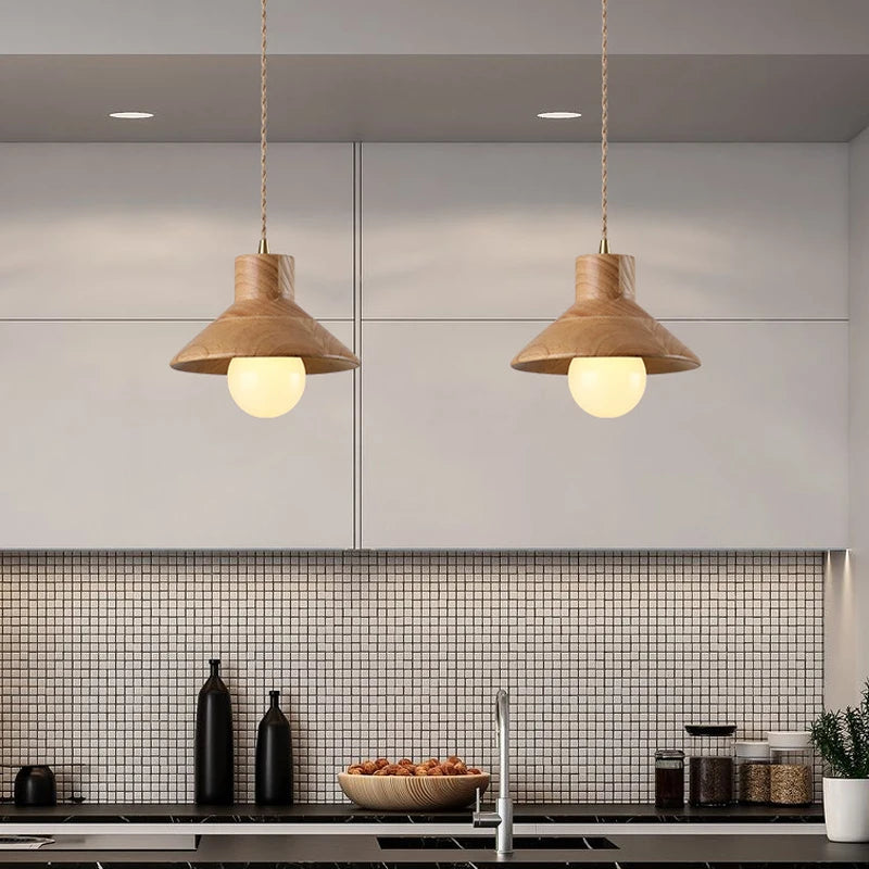 Modern kitchen with two Nordic wood pendant lights over island, blending farmhouse charm with minimalist lighting design.