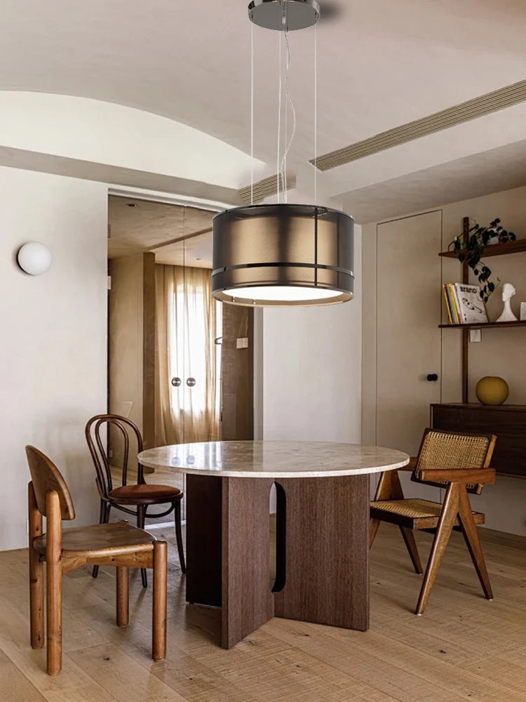 Modern Italian ceiling chandelier over a wood and marble dining table in a warm-toned, contemporary home interior.