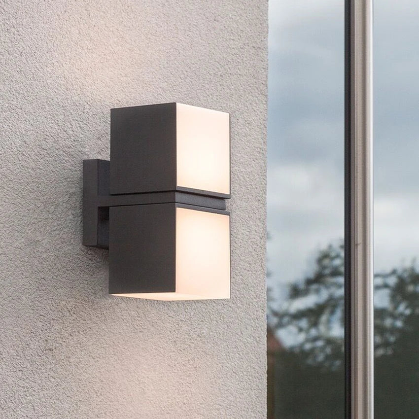 Mounted LUXELY rotatable outdoor wall lamp on exterior wall, providing stylish and durable illumination for garden or patio areas.