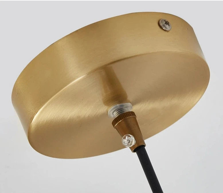 Ceiling mount detail of LUXELY pendant light in brushed brass, highlighting quality construction for home or office lighting.