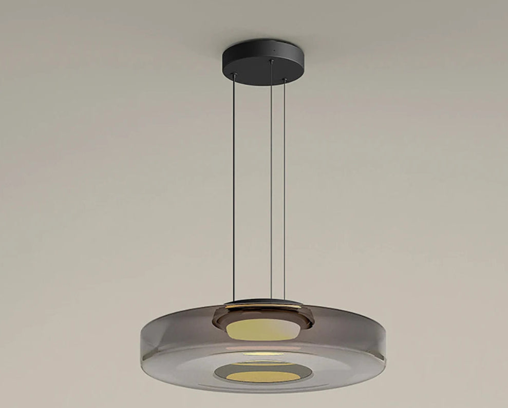 Smoke grey glass pendant light with 45cm diameter and 11cm height. Features LED lighting and adjustable suspension.