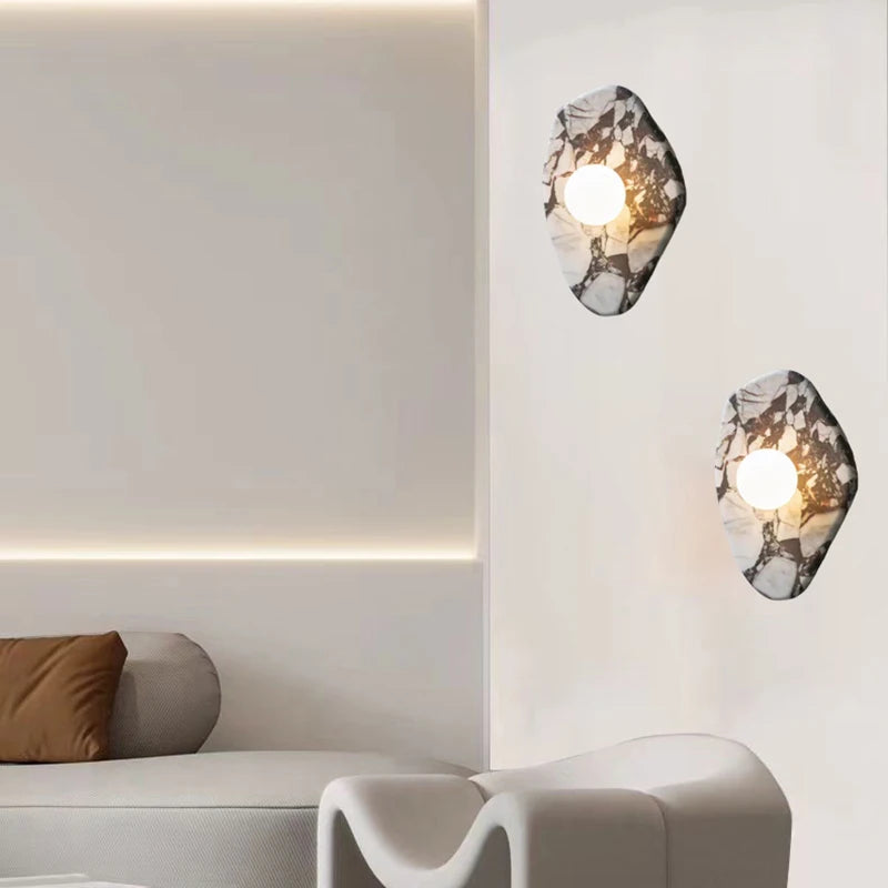 Pair of G9 Stone Wall Lights with glass ball sconces installed in a minimalist living room, providing soft ambient lighting.