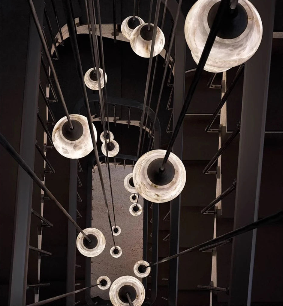 Top-down view of multiple marble LED pendant lights in stairwell. Marble LED pendant light – modern ceiling lamp dimmable for vertical spaces.