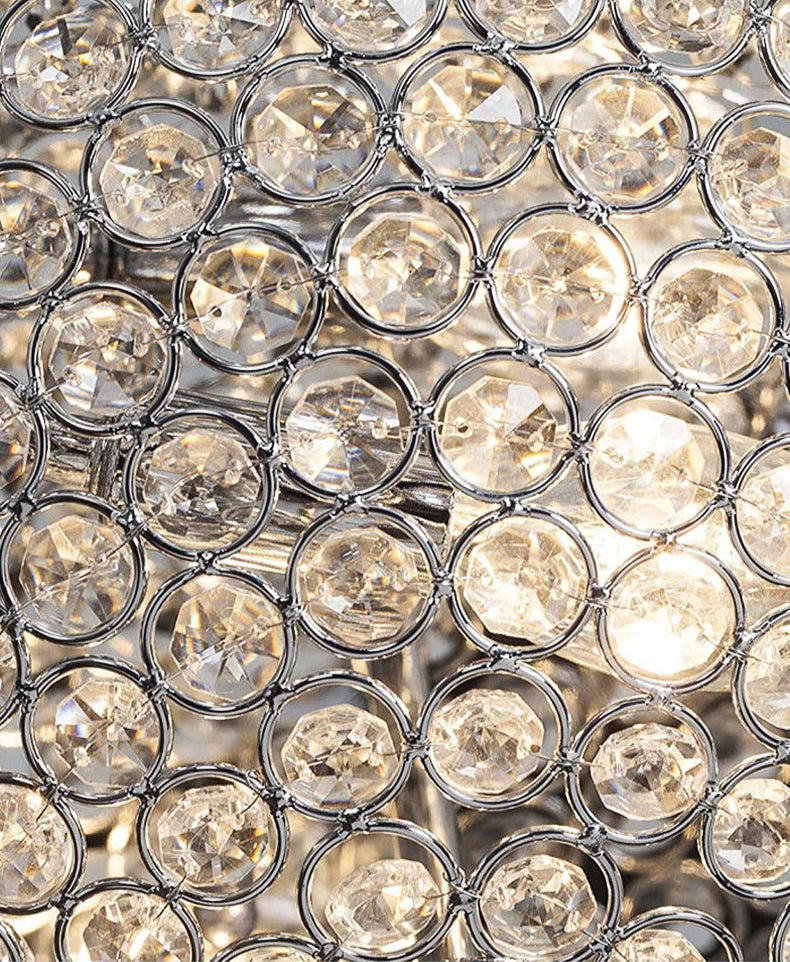 Close-up of illuminated crystal elements in luxury LED chandelier, highlighting warm light reflection.