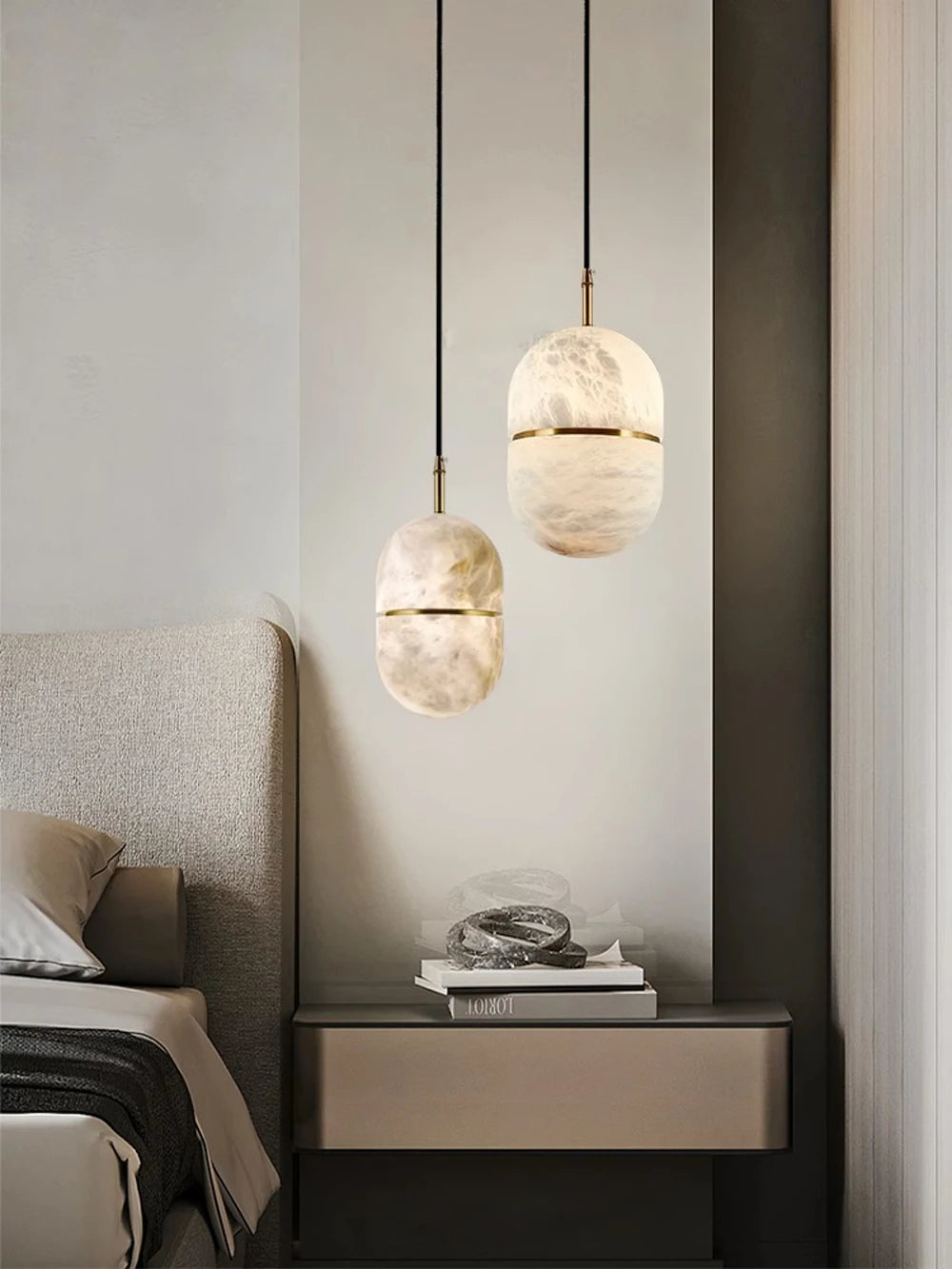 Pair of oval marble LED pendant lights beside a bed. Marble LED pendant light – modern ceiling lamp dimmable for bedroom lighting.