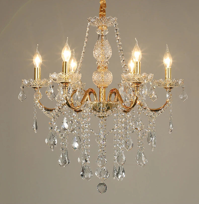 Golden crystal chandelier with five LED candle lights and cascading crystals, perfect for dining or lobby areas.
