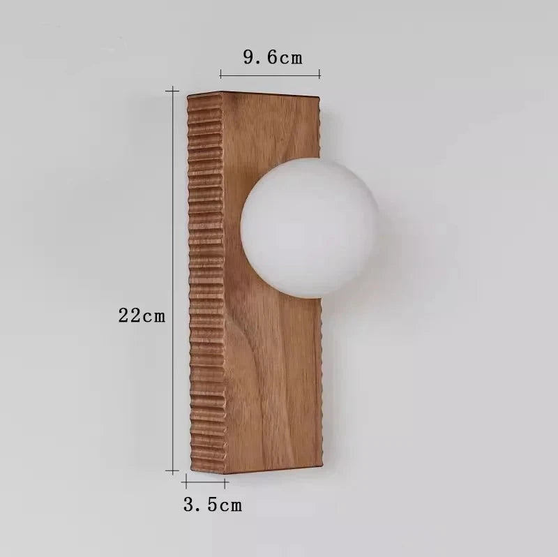 Dimensions of LUXELY rectangular wood wall lamp shown, measuring 22cm x 9.6cm x 3.5cm with a globe light.