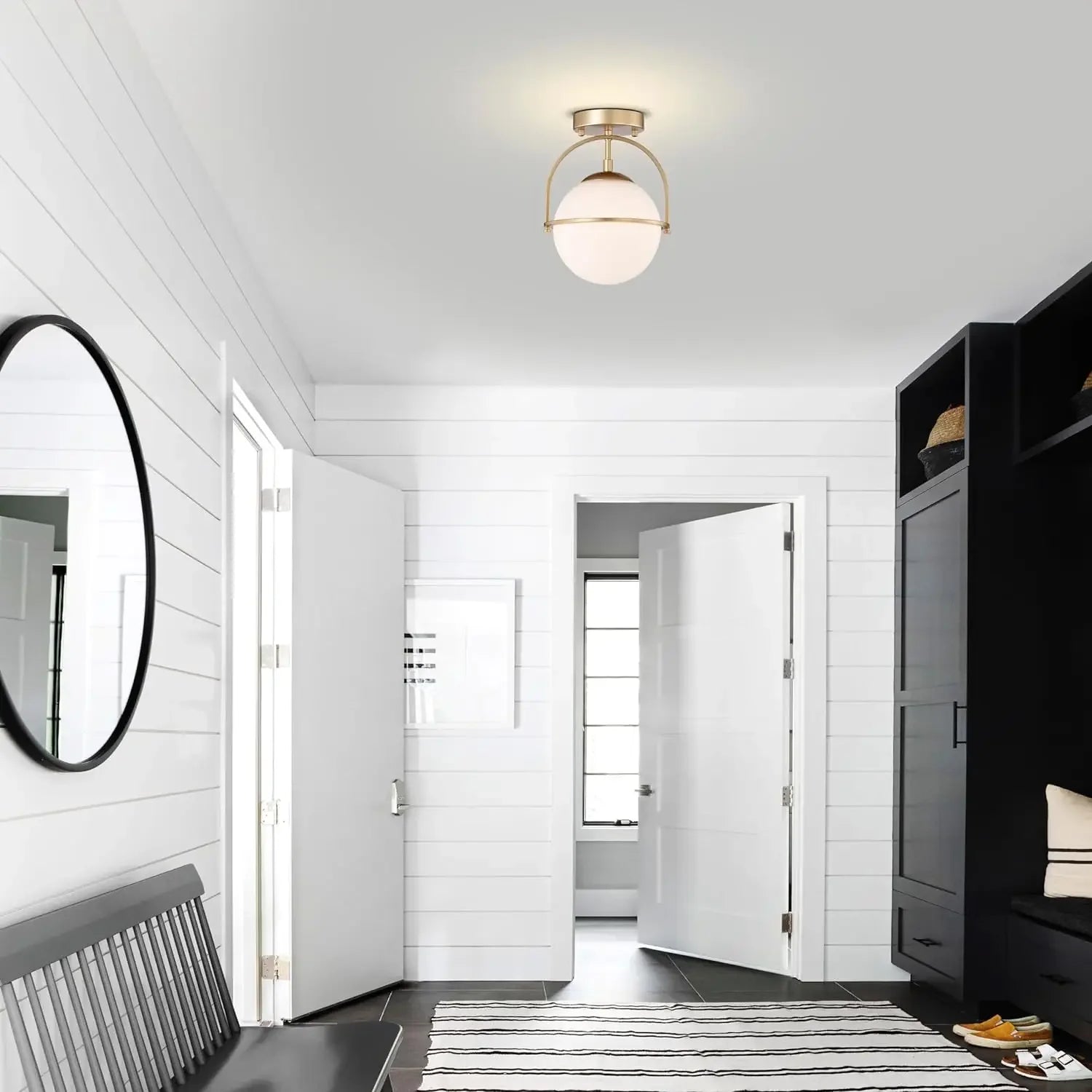 Stylish Nordic ceiling light with milky glass globe in a white hallway, perfect for contemporary home lighting solutions.