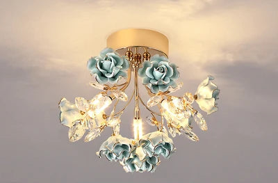Blue kids rose crystal chandelier with gold base and crystal embellishments, perfect for modern children's bedroom or nursery lighting.