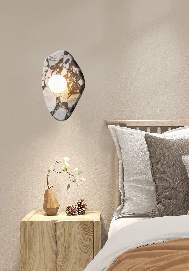 G9 Glass Ball Sconce on a natural stone base used as a bedside wall light, adding warmth and elegance to bedroom decor.