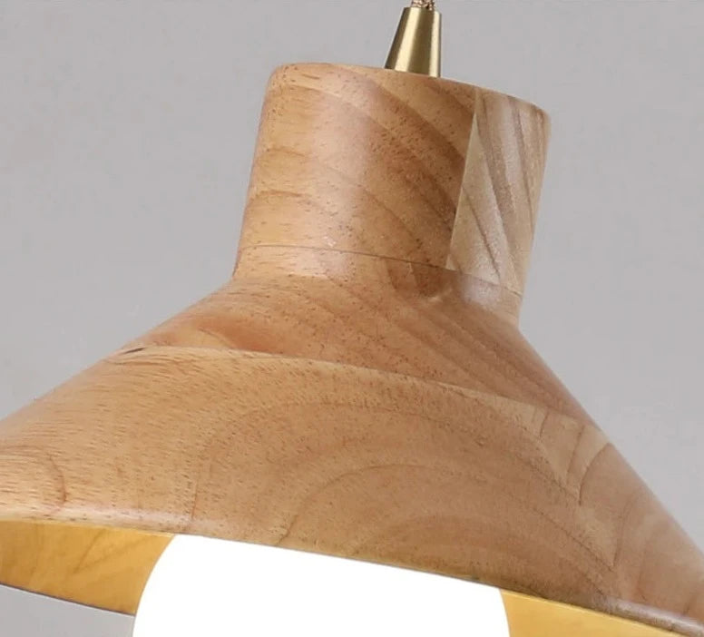 Detail of conical wood shade on Nordic pendant light, highlighting natural grain and smooth craftsmanship for home lighting.