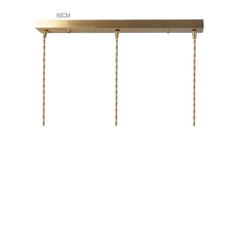 Rectangular brass ceiling mount with three cords for LUXELY pendant lights, 50cm wide, suitable for linear pendant arrangements.