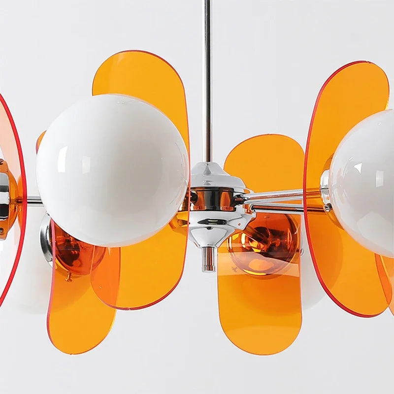 Detailed view of orange acrylic panels and chrome fixture on Bauhaus retro chandelier, highlighting its artistic LED design.