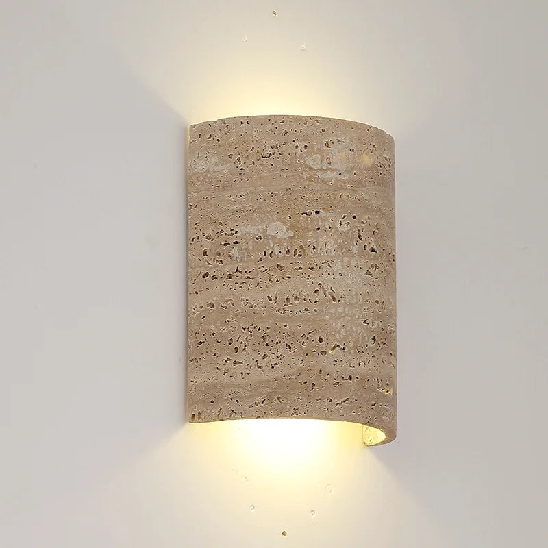 Vintage natural travertine flush wall lamp IP65 glowing warmly, ideal for ambient lighting in modern or rustic interiors.