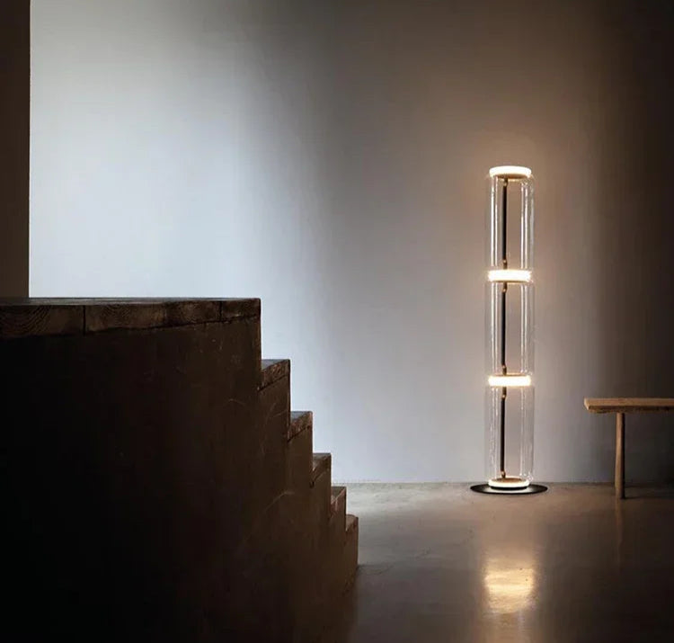 Italian glass floor lamp – nordic minimalist design with three-section LED-lit glass, enhancing a modern stairway corner.