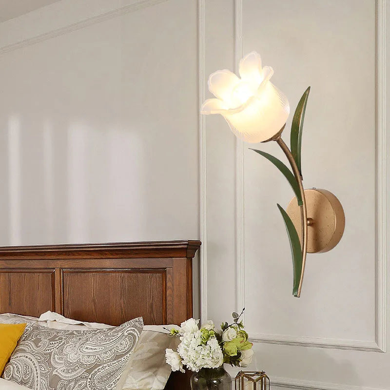 Retro LED French Pastoral Wall Lamp mounted beside a wooden bed, enhancing cozy bedroom ambiance with elegant floral design.