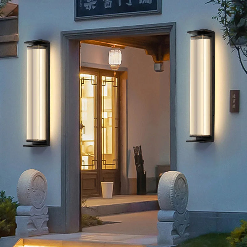 Pair of stainless steel outdoor wall lamps flanking a traditional entrance, offering durable waterproof lighting.
