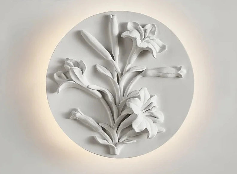 Round wall sconce with blooming lilies in sculpted relief, dimmable LED light perfect for vintage bathroom or hallway lighting.