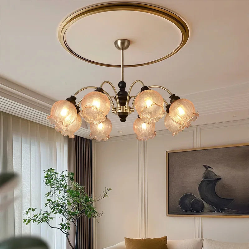 American chandelier with modern crystal LED lights in a living room, featuring elegant flower-shaped glass shades and black-gold frame.