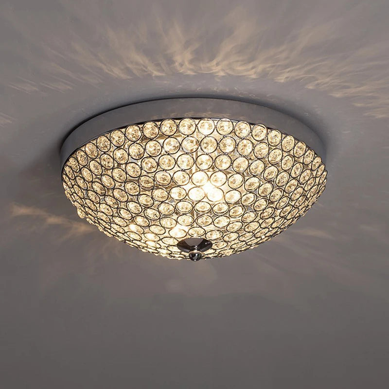 Crystal ceiling light - luxury LED modern chandelier with silver finish, mounted on ceiling casting elegant light patterns.