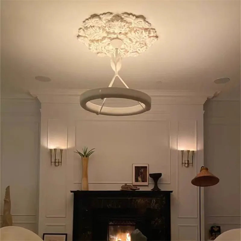 Minimalist carved plaster chandelier - french farmhouse ceiling light with circular LED ring, enhancing cozy living room ambiance.