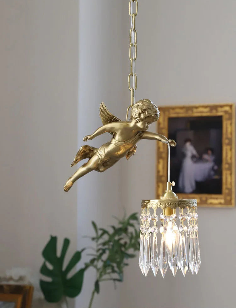 Flying angel copper chandelier with crystal pendant, suspended in a softly lit room with classic decor.