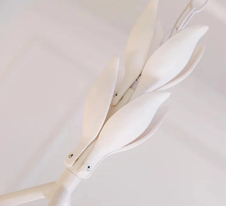 Leaf-shaped suspension detail of carved plaster chandelier - french farmhouse ceiling light, blending nature with elegance.