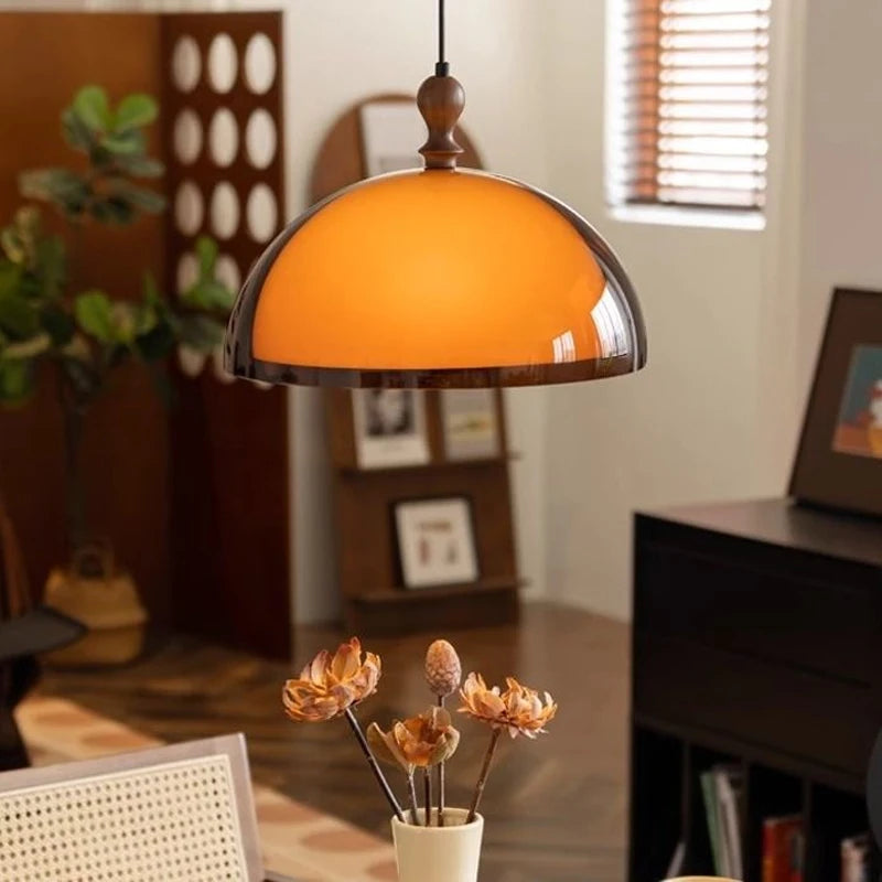 Modern LED Pendant Light with amber glow, enhancing a cozy dining area with elegant and energy-efficient lighting.