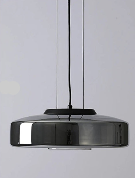Smoke grey glass pendant light shown on and off. LED lighting with a sleek, modern design for kitchen or dining areas.