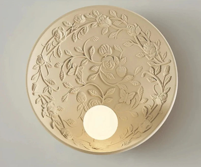 Round wall sconce with carved rose pattern, vintage imperial design ideal for romantic bedroom or luxury bathroom lighting.