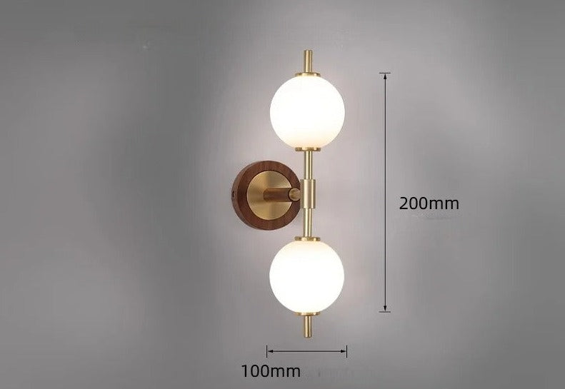 Brass wall light fixture with dimensions 200mm height and 100mm depth, featuring dual globe design for compact spaces.