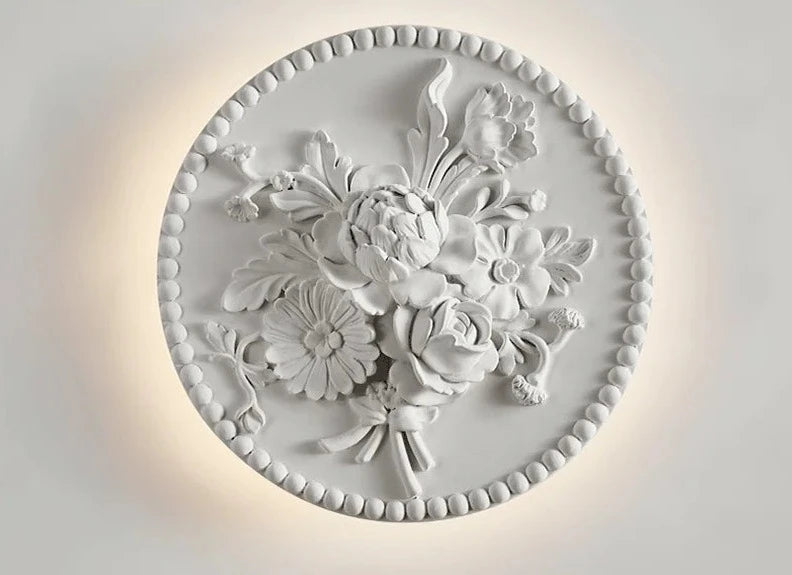 French round vintage sconce with bouquet relief and soft LED glow, ideal for royal-style wall lighting in living rooms or hotels.
